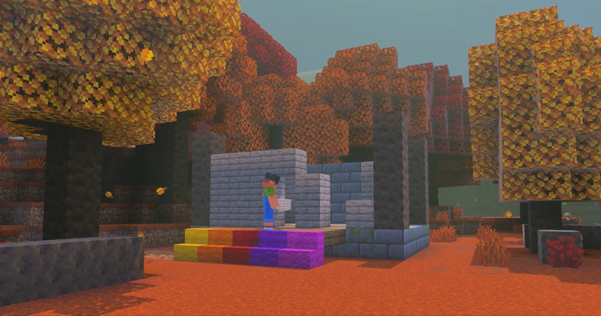 Poplars with yellow, orange, and red leaves around a small build in a Minecraft dappled forest
