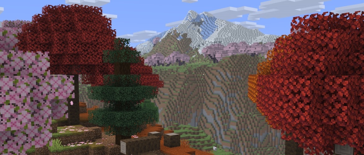 An autumn forest of poplars and cherry trees, with a snow-capped mountain in the distance